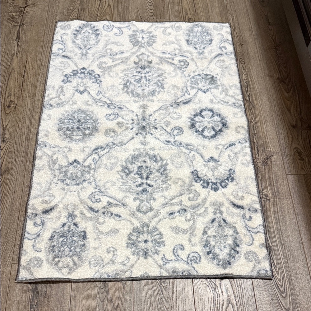 Off white rug with gray and blue design